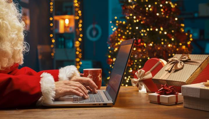 Santa typing on computer and making a naughty or nice list for apps