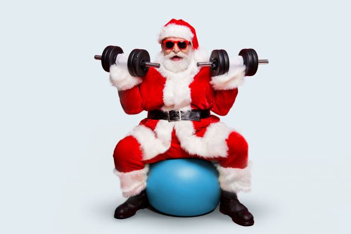 Santa training with the exercise ball and weights