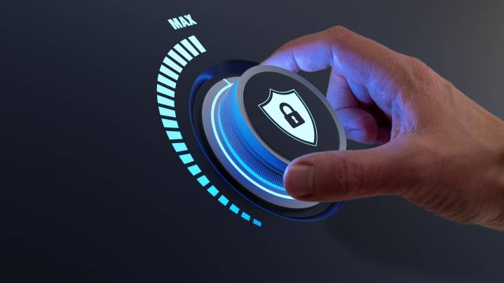 Security concept with person increasing the password protection level by turning a knob and defend against cyber attack